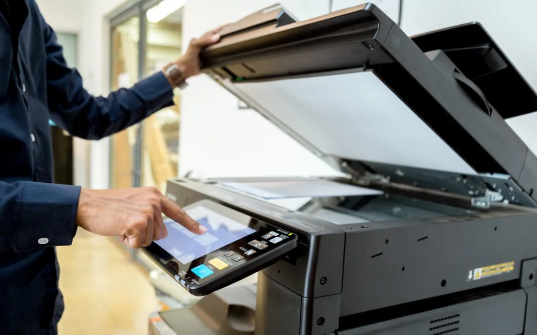 Businessman using a network printer setup to print documents.
